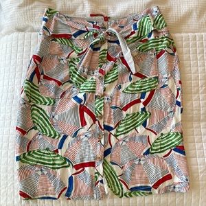 Anthropologie beach umbrella printed skirt with button front and tie waist.